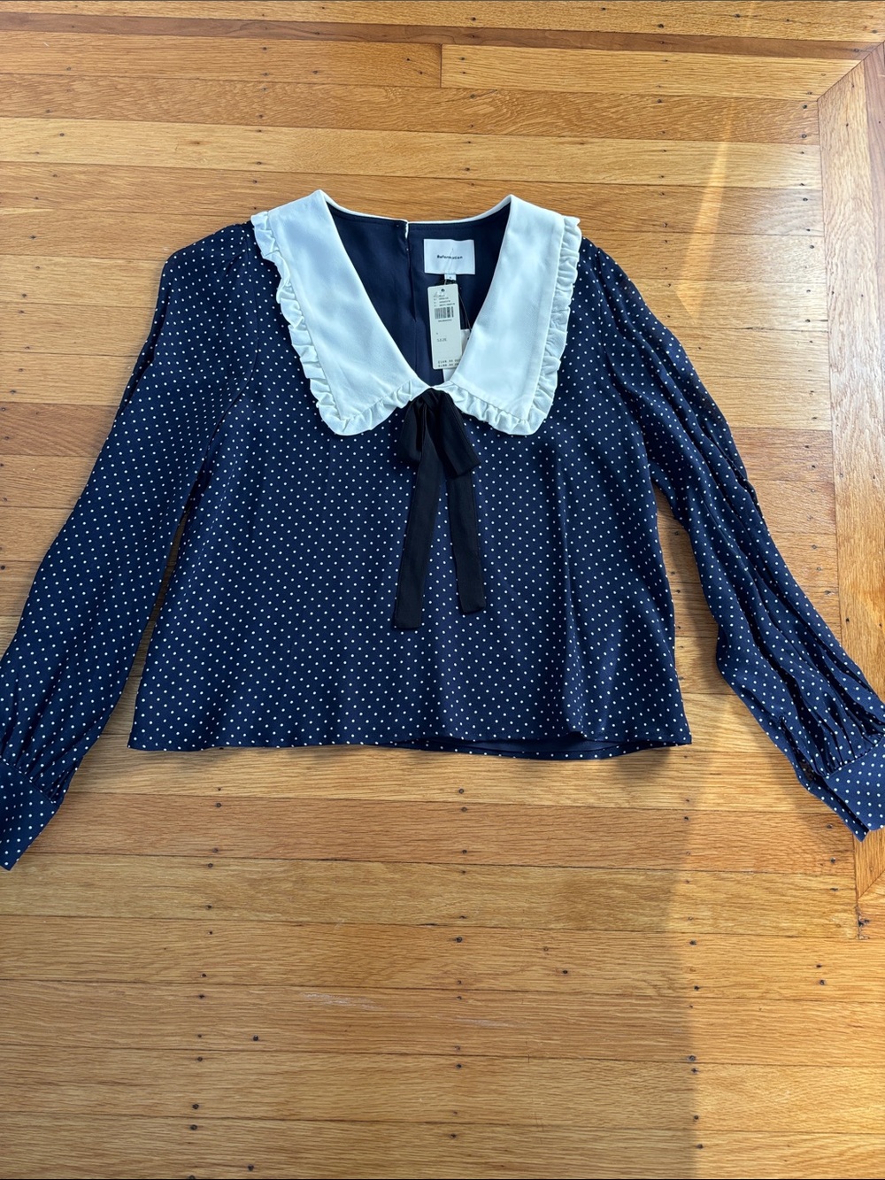 Reformation Navy Polka Dot Blouse with White Ruffled Collar and Black Tie. NWT